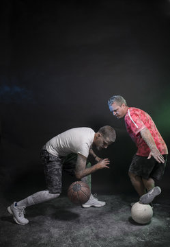Studio portrait of sportsmen using balls