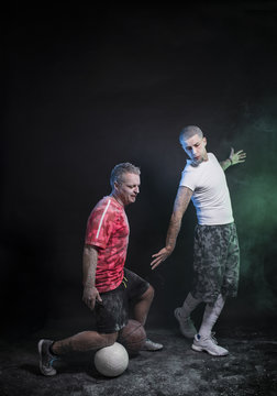 Studio portrait of sportsmen using balls