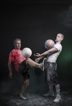Studio portrait of sportsmen using balls