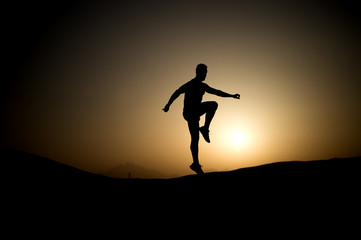 Fototapeta na wymiar Athlete with muscular body in dusk