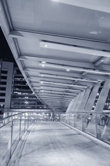 Empty pedestrian walkway over busy street in urban city