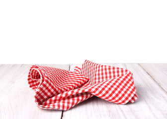 Red checkered gingham picnic cloth on table isolated.