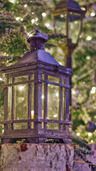 Сhristmas lantern near the fir stands on a wooden log Christmas and holiday atmosphere