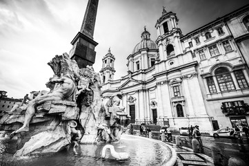 Tourists visit Piazza Navona with fountain in Rome, Italy. Photo in black and white