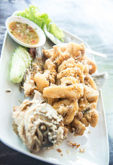 Fried Giant gourami fish  with garlic and seafood sauce, Uthai Thani province, Thailand
