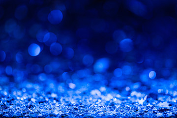 christmas background with blue blurred shiny confetti stars