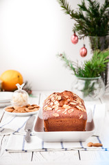 On a dish an orange cupcake with almonds