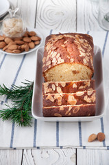 On a dish an orange cupcake with almonds