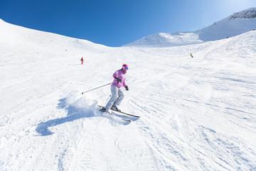 Fototapeta na wymiar woman skiing in the mountains