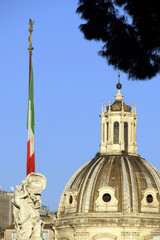 Rome (Italy). Flag of the Republic of Italy with the dome of Santa Maria di Loreto in Rome