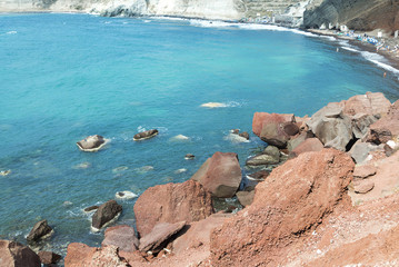Beach with red sand. The island of Santorini.
