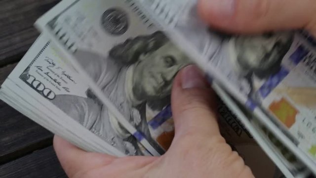 Counting american paper money close-up. Man hands counting a lot of one hundred dollar bills