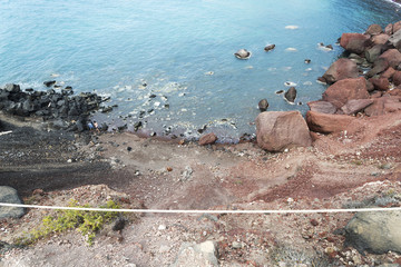 Beach with red sand. The island of Santorini.