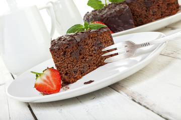 Chocolate cake on a plate, tilted view