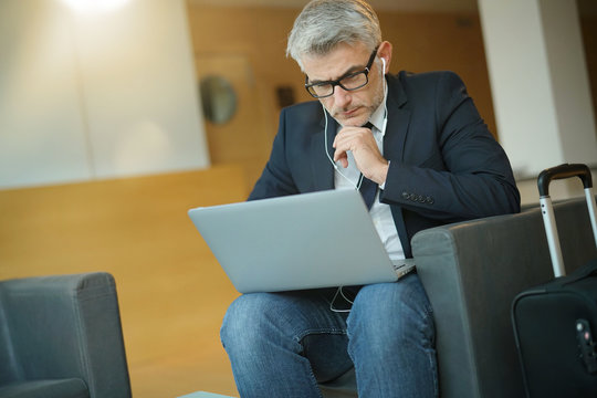 Businessman in waiting room connected wit laptop