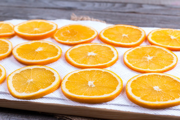 Sliced orange on a board with a paper towel