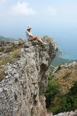 Young woman on top of mountain