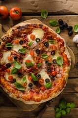 Rustic pizza with tomato, cheese, salami