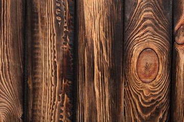 Texture of boards of dark old brown wood
