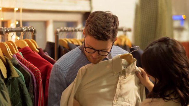 couple choosing clothes at vintage clothing store