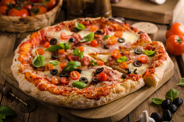Rustic pizza with tomato, cheese, salami