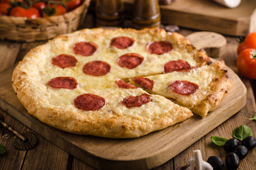 Rustic pizza with tomato, cheese, salami