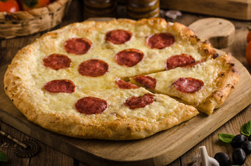 Rustic pizza with tomato, cheese, salami