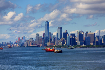 Fototapeta premium Freighters in Harbor with New York City in Background