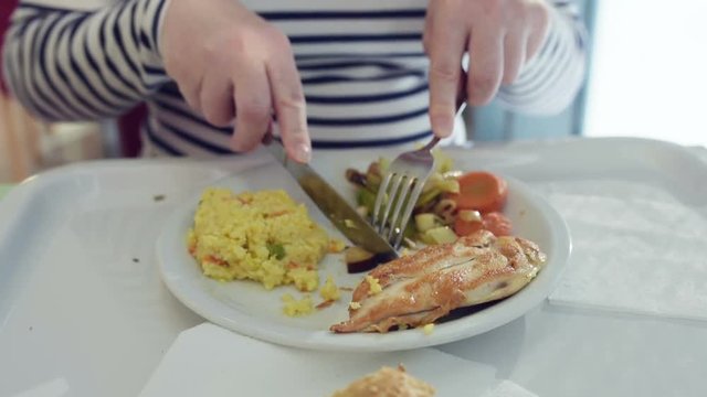 Woman eating lunch in express restaurant. Female person having grilled chicken and vegetables for meal, selective focus.