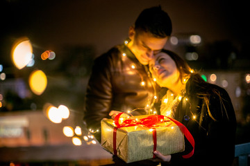 romantic surprise for Christmas, woman receives a gift from her boyfriend