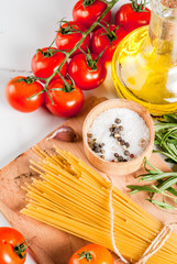Italian food cooking, ingredients for preparation pasta spaghetti - tomato, garlic, olive oil, spices, white marble background, copy space