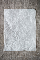 crumpled sheet of paper on a gray background. Place for entries