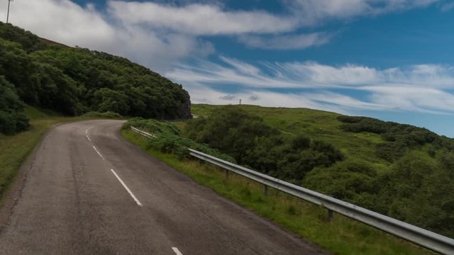 hyperlapse POV shot from a camera attached to the front of a vehicle driving through beautiful empty roads in the scottish highlands