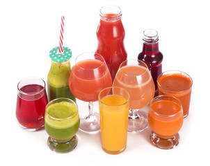 Glasses with fresh organic vegetable and fruit juices isolated on white.