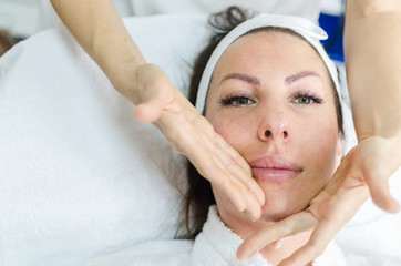 Face massage after peeling in beauty spa salon