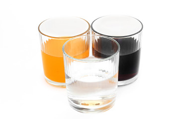 Different drinks in three glasses. Water in a glass on a white background. Drink. Glass