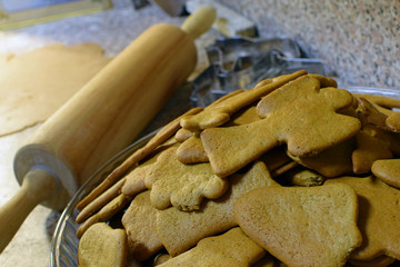 Christmas homemade gingerbread cookies, rolling pin, cutters and dough.