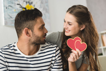 woman giving valentines day greeting card to boyfriend