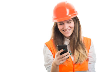 Young engineer girl reading messages on smartphone
