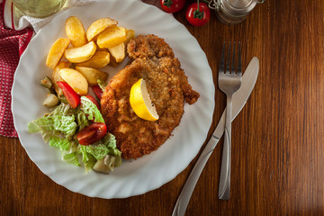 Breaded viennese schnitzel with baked potatoes