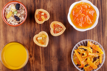 Healthy breakfast. Ceramic bowl with oat flakes, dried fruits, nuts on wood background