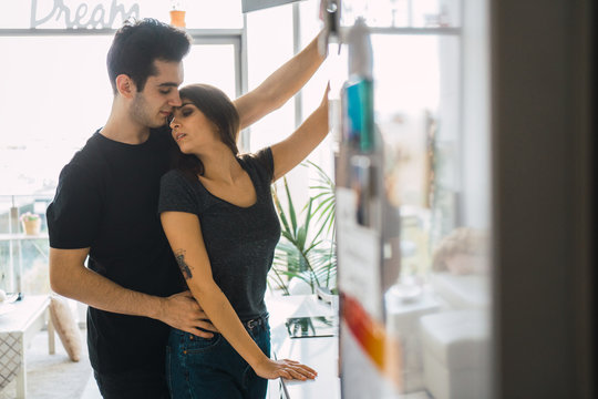 Man helping to woman on kitchen