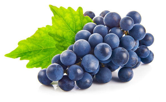 Blue grapes with green leaf healthy eating, isolated on white © Yasonya