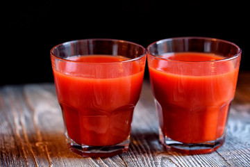 Glass of tomato juice with fresh tomatoes