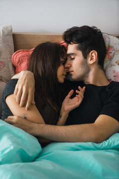 Couple kissing in bed
