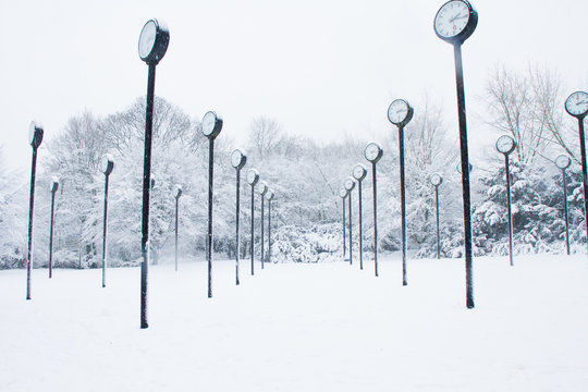 Clocks standing in a snow covered park in the centre of the town of Düsseldorf