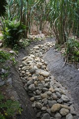 Dry creek bed filled with river rocks
