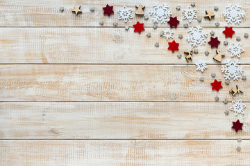 Christmas decoration with white snowflakes, red stars and wooden
