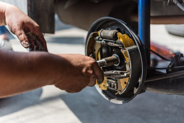 Drum brake and asbestos brake pads at car garage
