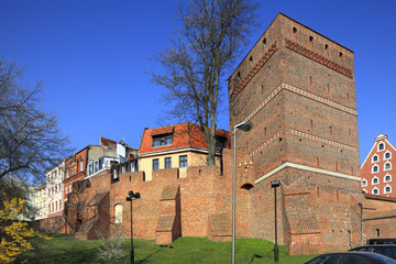 Poland, Greater Poland province, Torun - 2012/07/08: Defence walls of old town and Leaning Tower in Torun